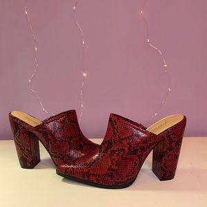 Red snakeskin, slip on pumps. Never worn.